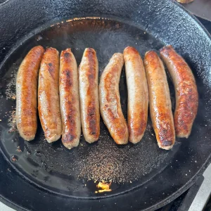 Maple Sausage Links grilling on a skillet, nice and golden brown and ready to serve